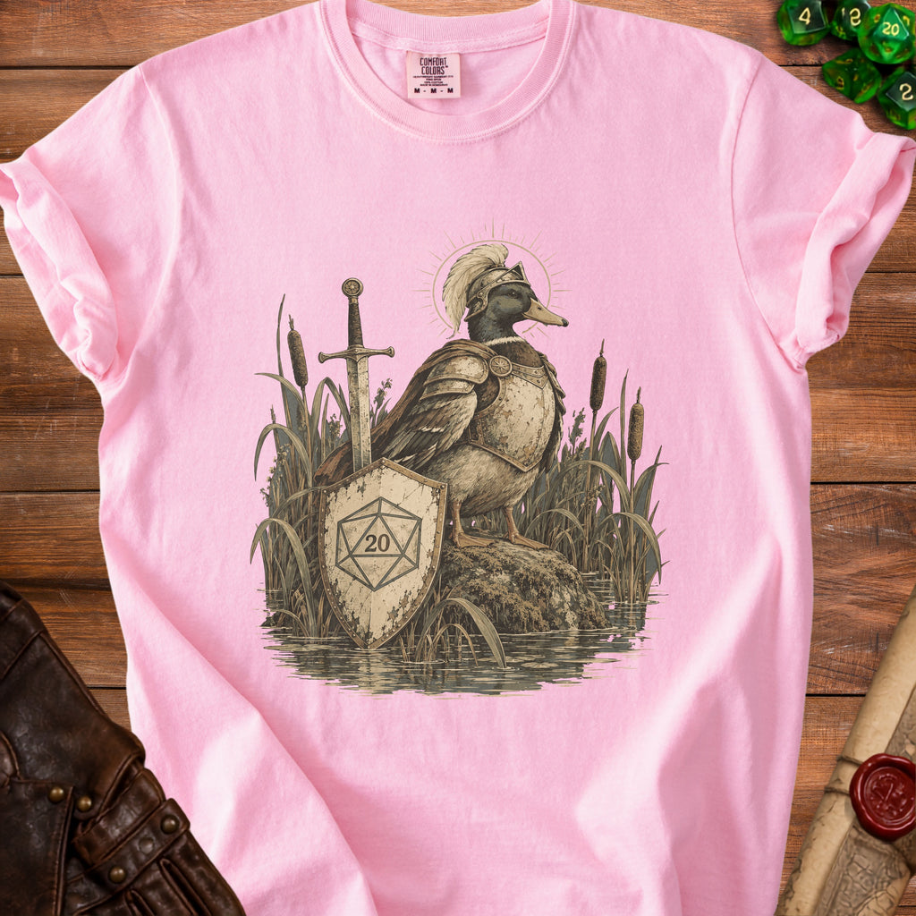 Knighted duck in armor with sword, shield, and d20 die on pink t-shirt.