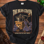 Black t-shirt with "The Bean Coven" and a coffee grinder ritual.