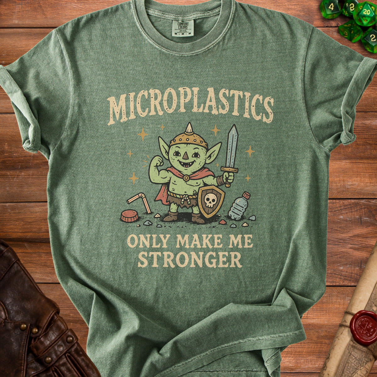 Green t-shirt with a goblin holding a sword and shield, reading "Microplastics Only Make Me Stronger."