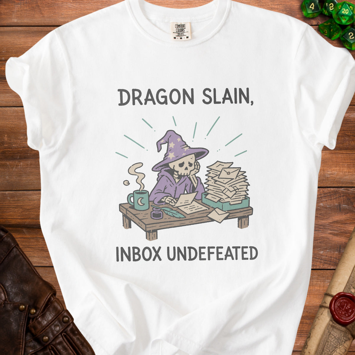 White t-shirt with illustration of a skeleton wizard at a desk, "Dragon Slain, Inbox Undefeated."