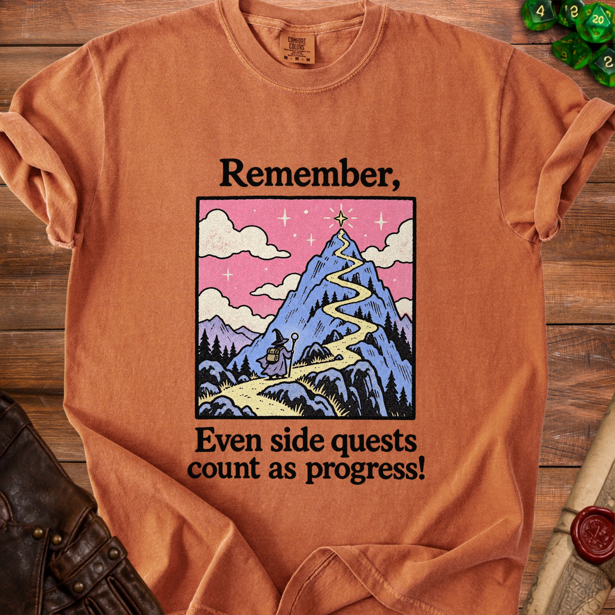 Orange t-shirt with "Remember, Even side quests count as progress!" and mountain graphic.