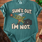Green t-shirt with a cartoon goblin and the text "Sun's Out. I'm Not."