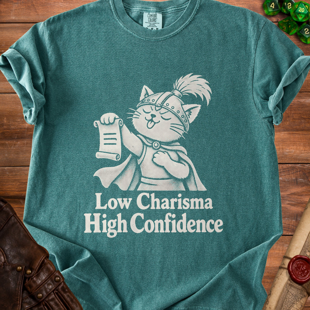 Green t-shirt with white graphic of a cat knight holding a scroll and text "Low Charisma High Confidence".
