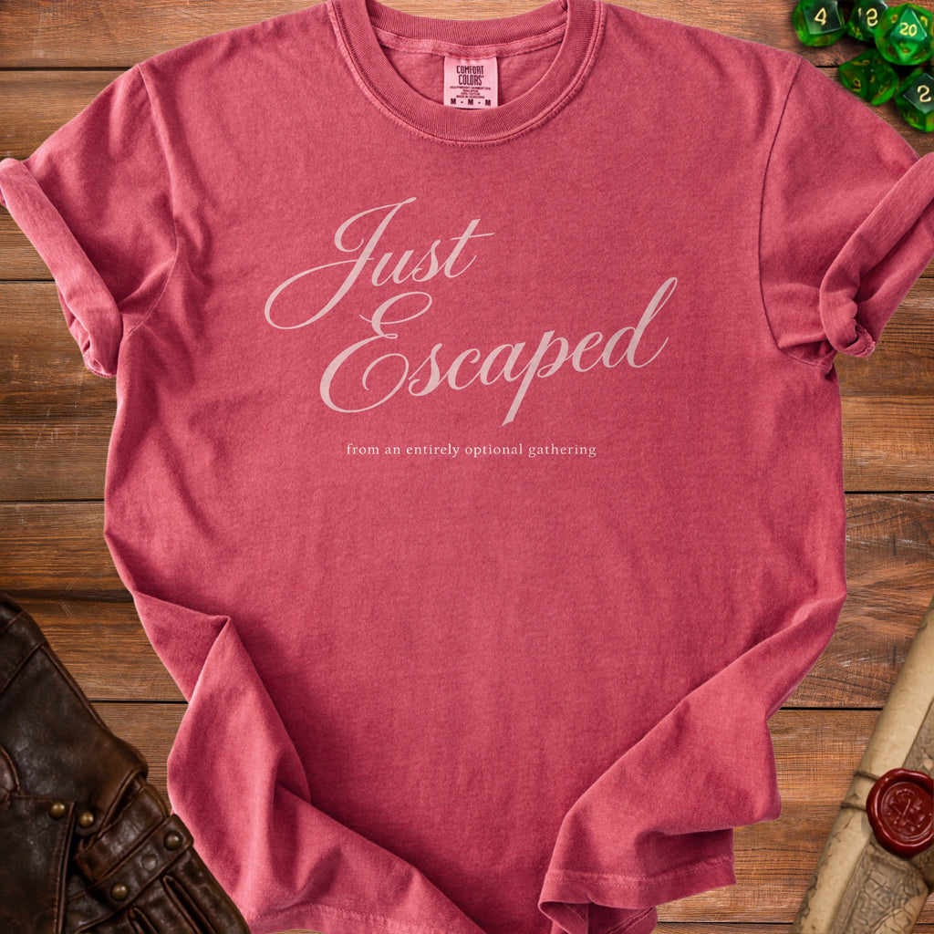Dusty rose t-shirt featuring the white text Just Escaped from an entirely optional gathering.