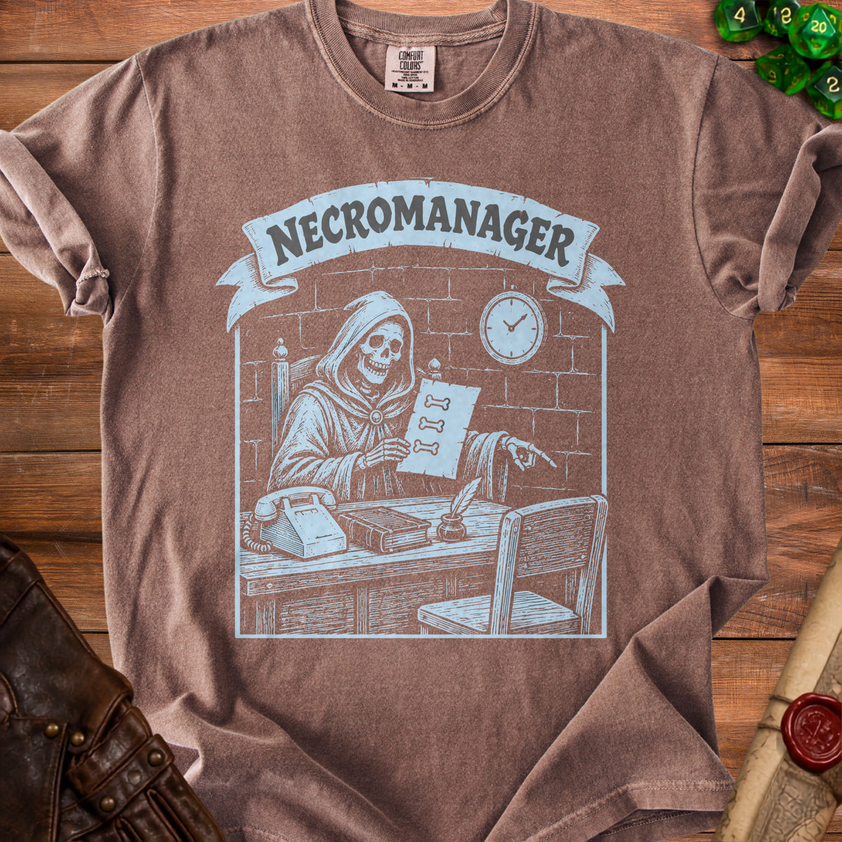 Brown t-shirt with "NECROMANAGER" text and a skeleton at a desk.
