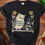 Black t-shirt with an owl, mouse, wizard hat, and flowers graphic.