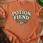 Orange t-shirt with "Potion Fiend" text and a potion bottle design.