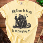 Yellow t-shirt with knight graphic and text "My Armor Is Heavy So Is Everything F'".