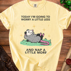 Yellow t-shirt with opossum graphic and text "Today I'm going to worry a little less and nap a little more."