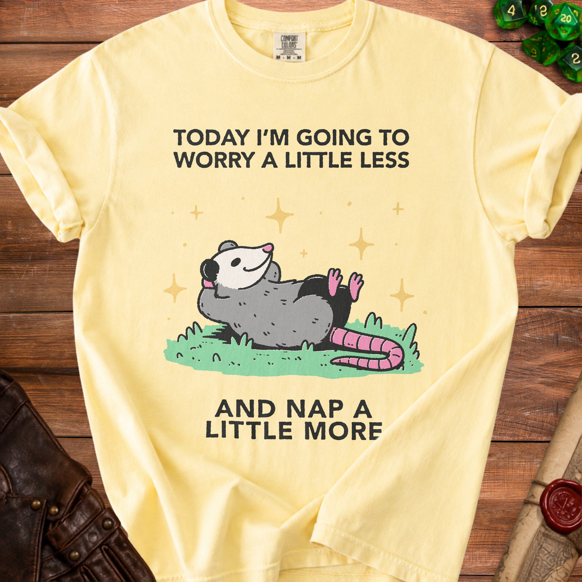 Yellow t-shirt with opossum graphic and text "Today I'm going to worry a little less and nap a little more."