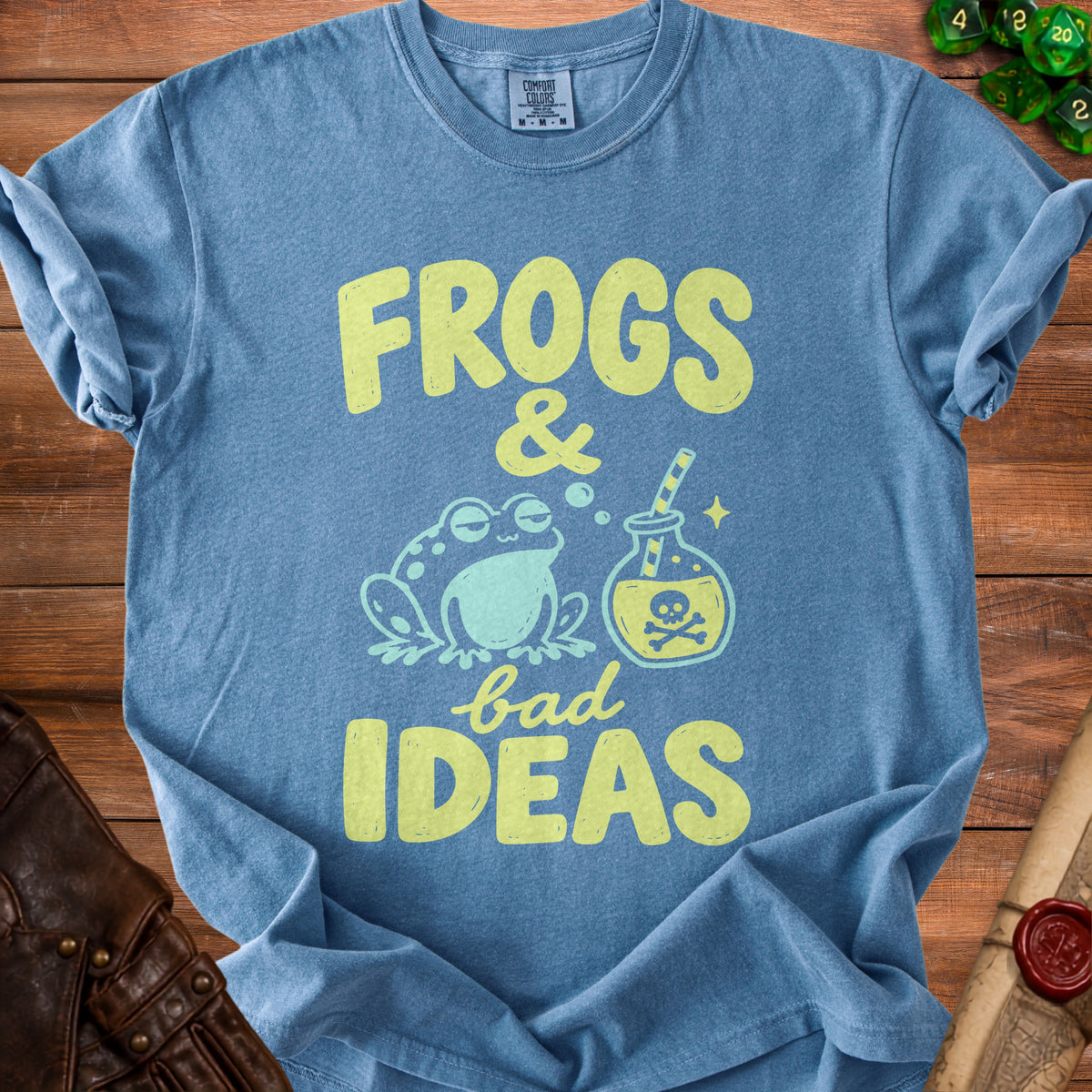 Blue t-shirt with "Frogs & bad IDEAS" graphic, a frog, and a potion.