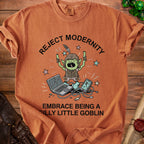 T-shirt with "Reject Modernity Embrace Being A Silly Little Goblin" text and a goblin character.