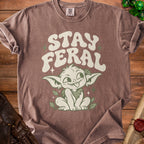Brown t-shirt with "STAY FERAL" text and a green creature graphic.