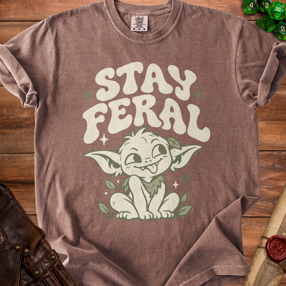 Brown t-shirt with "STAY FERAL" text and a green creature graphic.