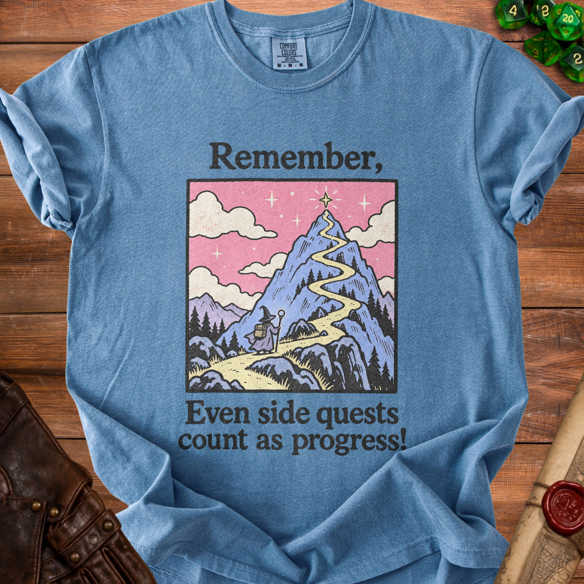 Blue t-shirt with graphic of wizard on mountain path, text: "Remember, Even side quests count as progress!"