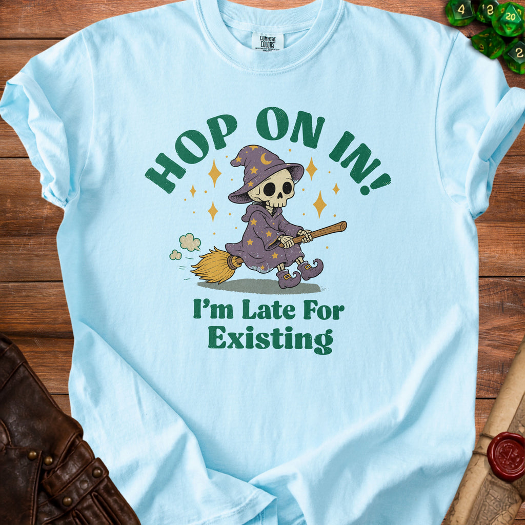 Light blue t-shirt with skeleton witch graphic and text "Hop On In! I'm Late For Existing".
