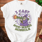 White t-shirt with a graphic of a wizard firing a rocket launcher that says "I Cast Non-Magic Missile".