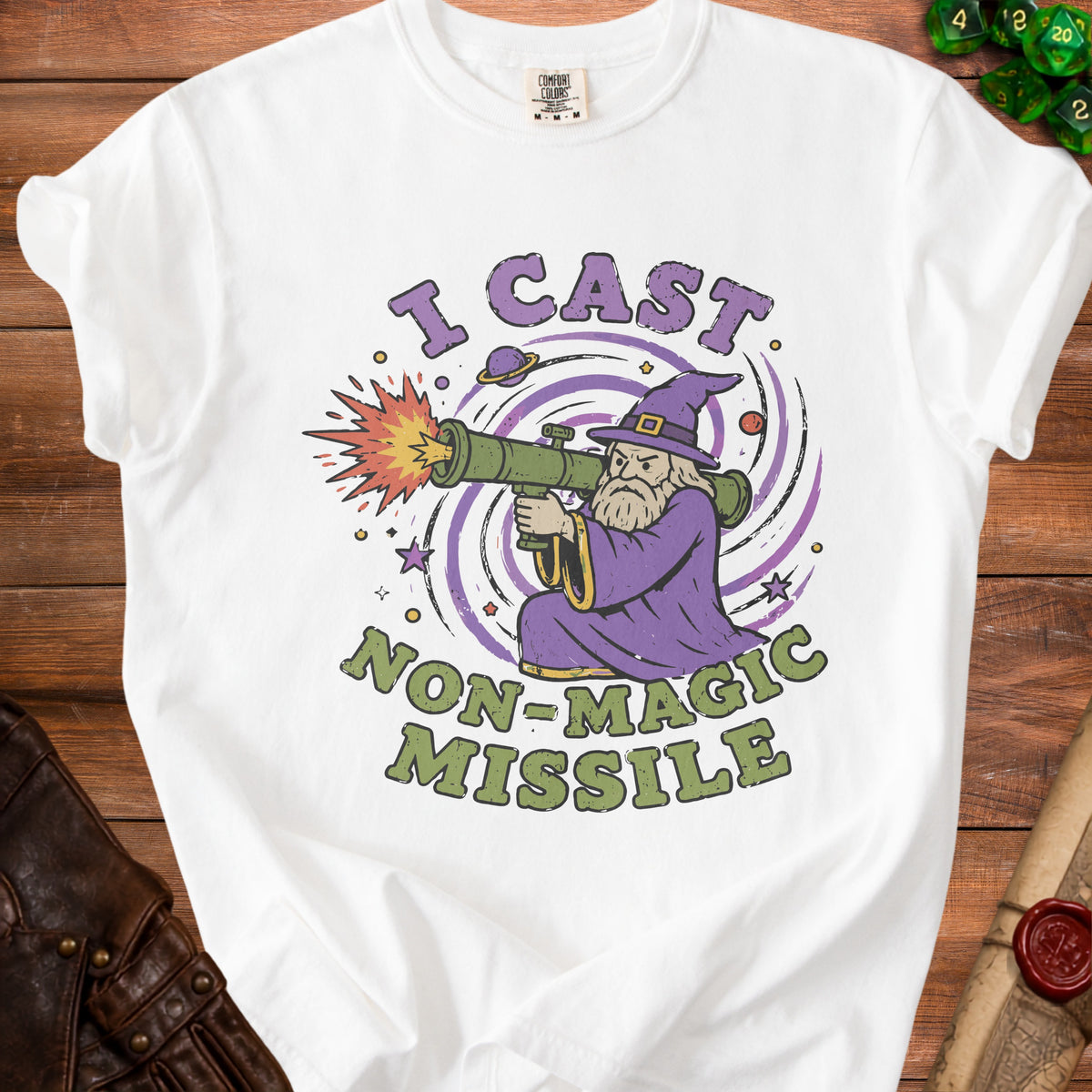 White t-shirt with a graphic of a wizard firing a rocket launcher that says "I Cast Non-Magic Missile".