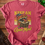 T-shirt with a monster chest design and text "KEEP AN Open Mind."
