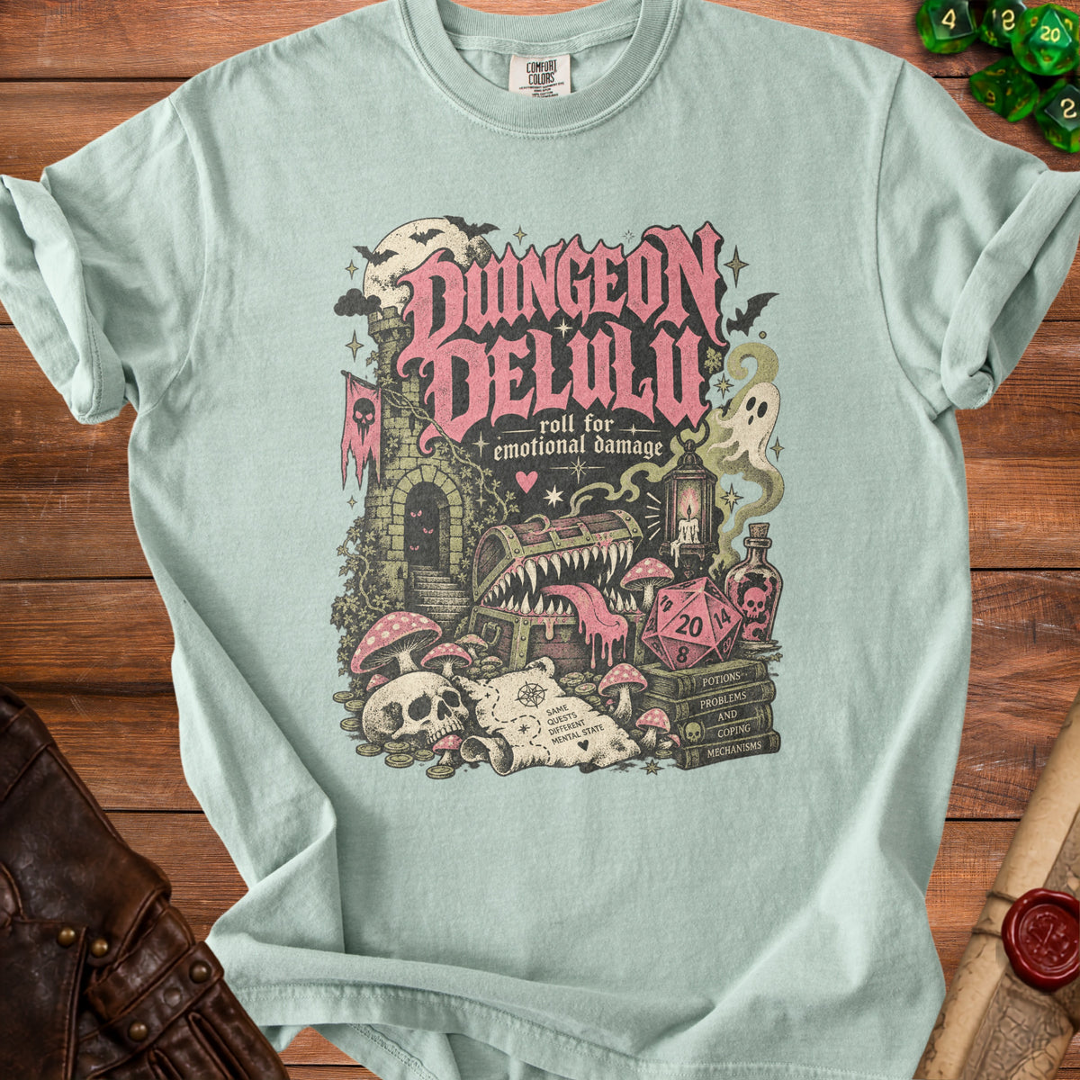 T-shirt with Dungeon Delulu graphic: "roll for emotional damage" and D20 dice.