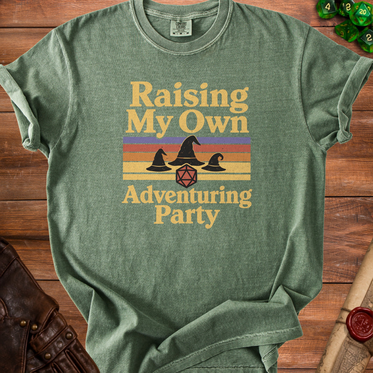Green t-shirt with "Raising My Own Adventuring Party" text and witch hats.