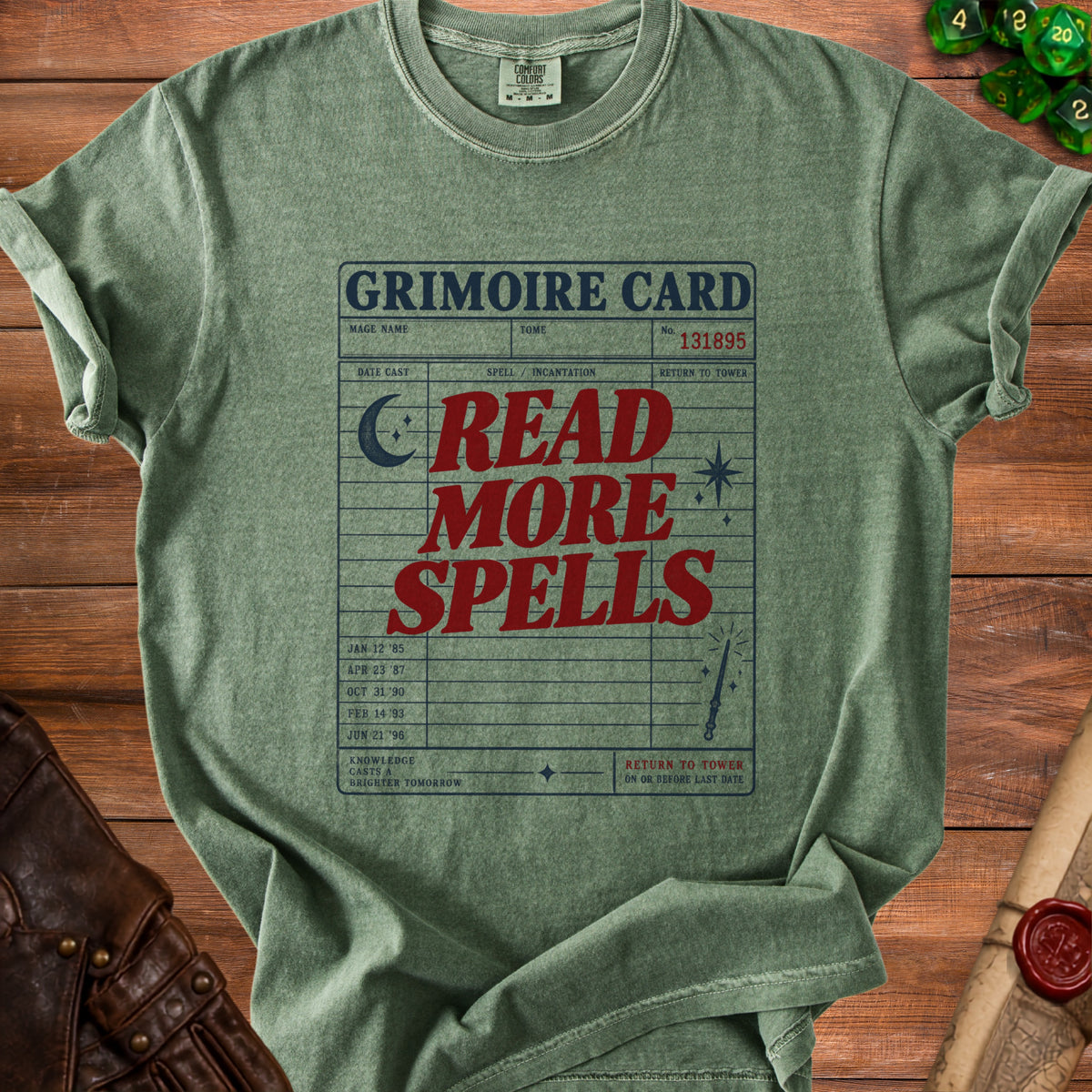 Green t-shirt with "Grimoire Card: Read More Spells" text and magical graphics.
