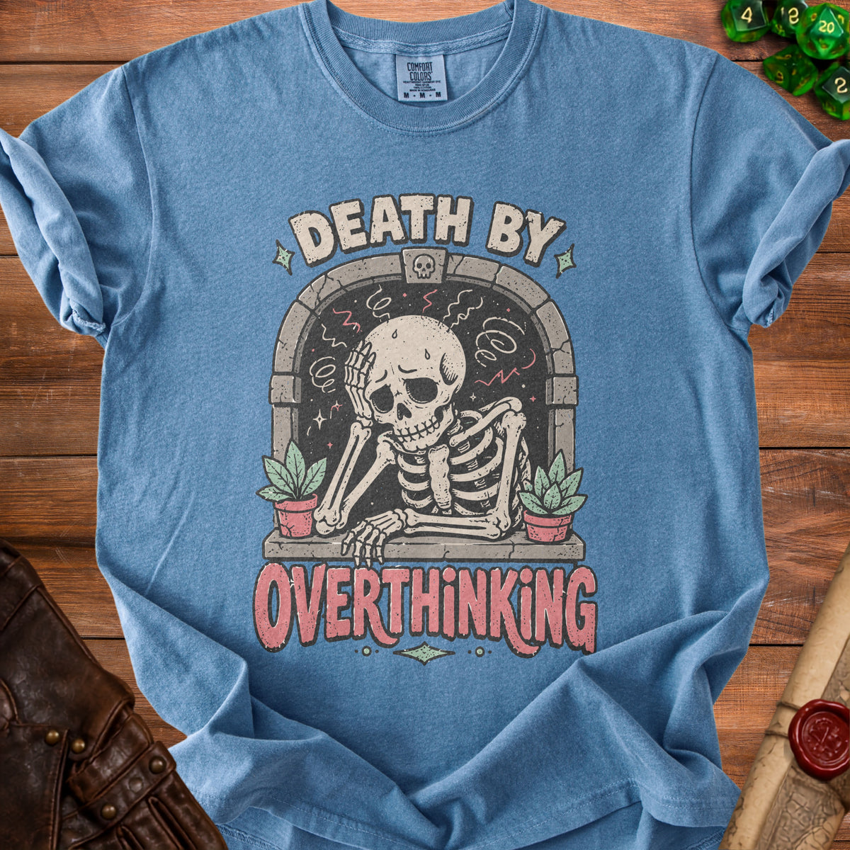 Blue t-shirt with skeleton graphic reading "DEATH BY OVERTHINKING".