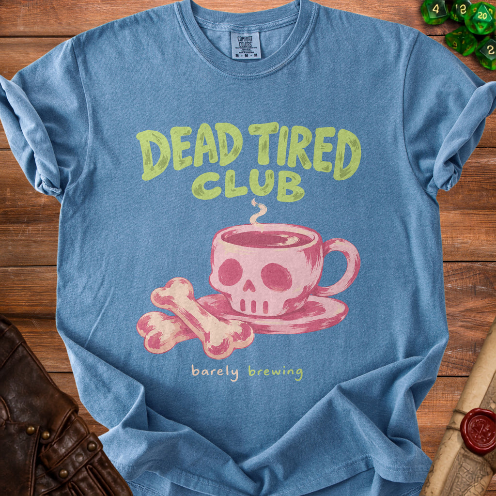 Blue t-shirt with "Dead Tired Club" and a skull coffee cup graphic.