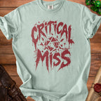 Light blue t-shirt with red "Critical Miss" text and a shattered dice graphic.