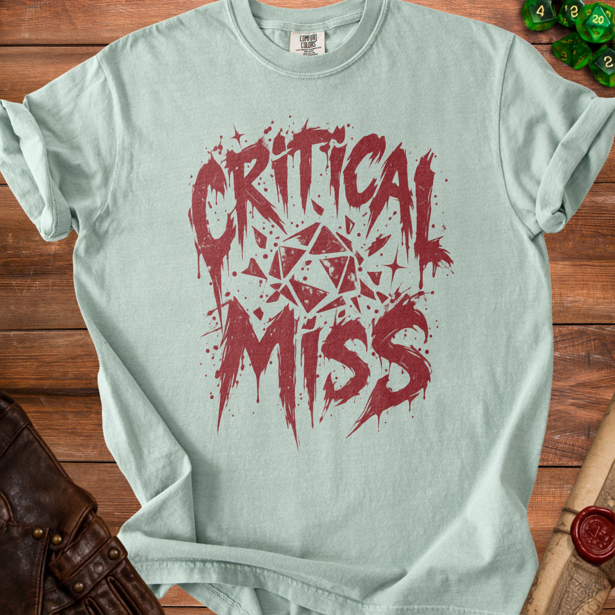 Light blue t-shirt with red "Critical Miss" text and a shattered dice graphic.