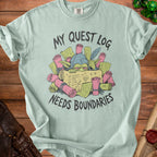 Light blue t-shirt with goblin and scrolls graphic reading "My Quest Log Needs Boundaries."