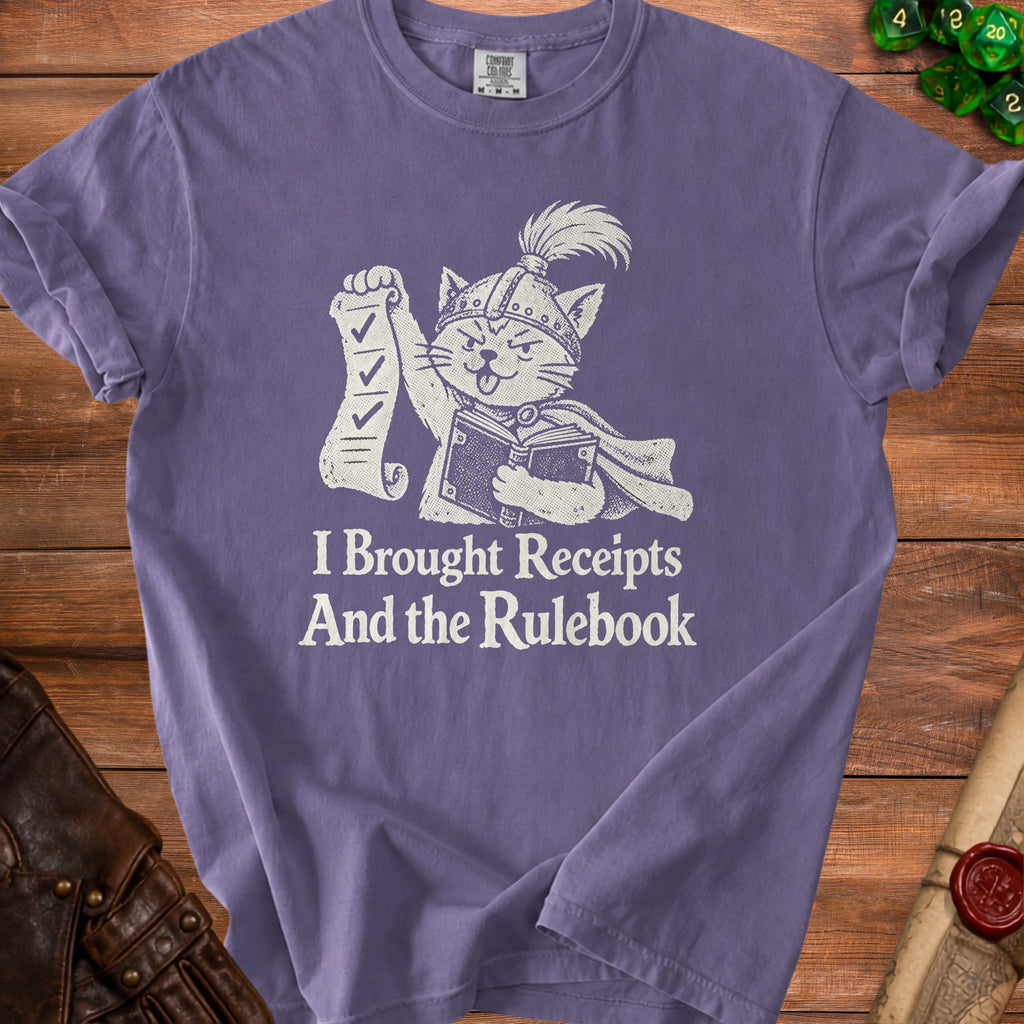 Purple t-shirt with graphic of cat holding receipts and book, text "I Brought Receipts And the Rulebook".