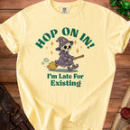 Yellow t-shirt with a skeleton wizard on a broom and text "I'm Late For Existing".