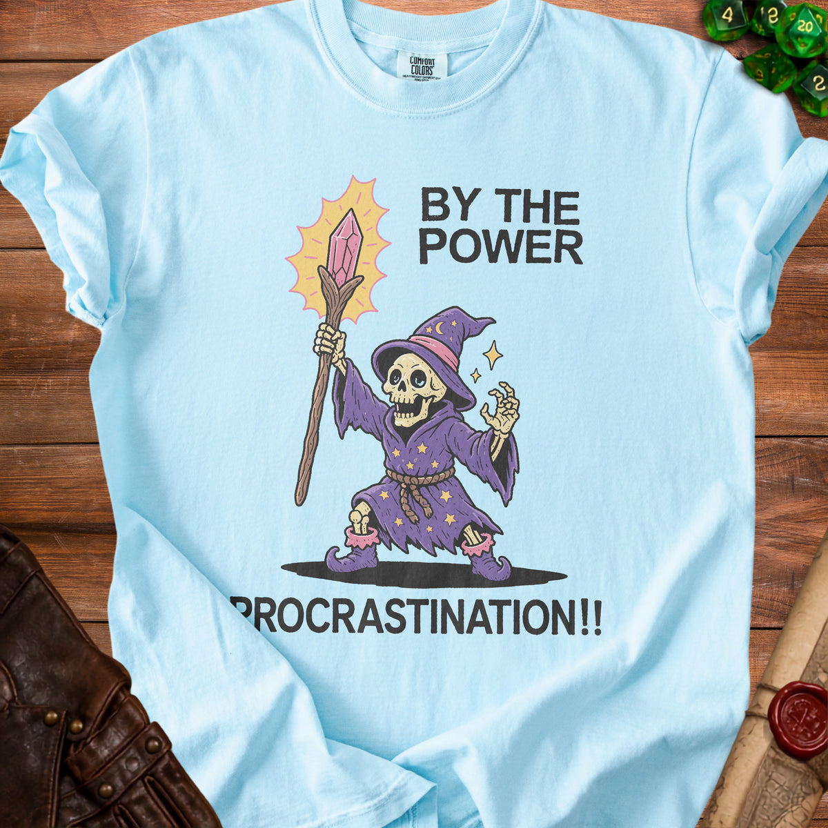 Light blue t-shirt with skeleton wizard graphic and text "By the Power Procrastination!!".