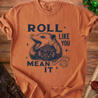 T-shirt with navy graphic of a possum holding dice, reading "ROLL LIKE YOU MEAN IT".