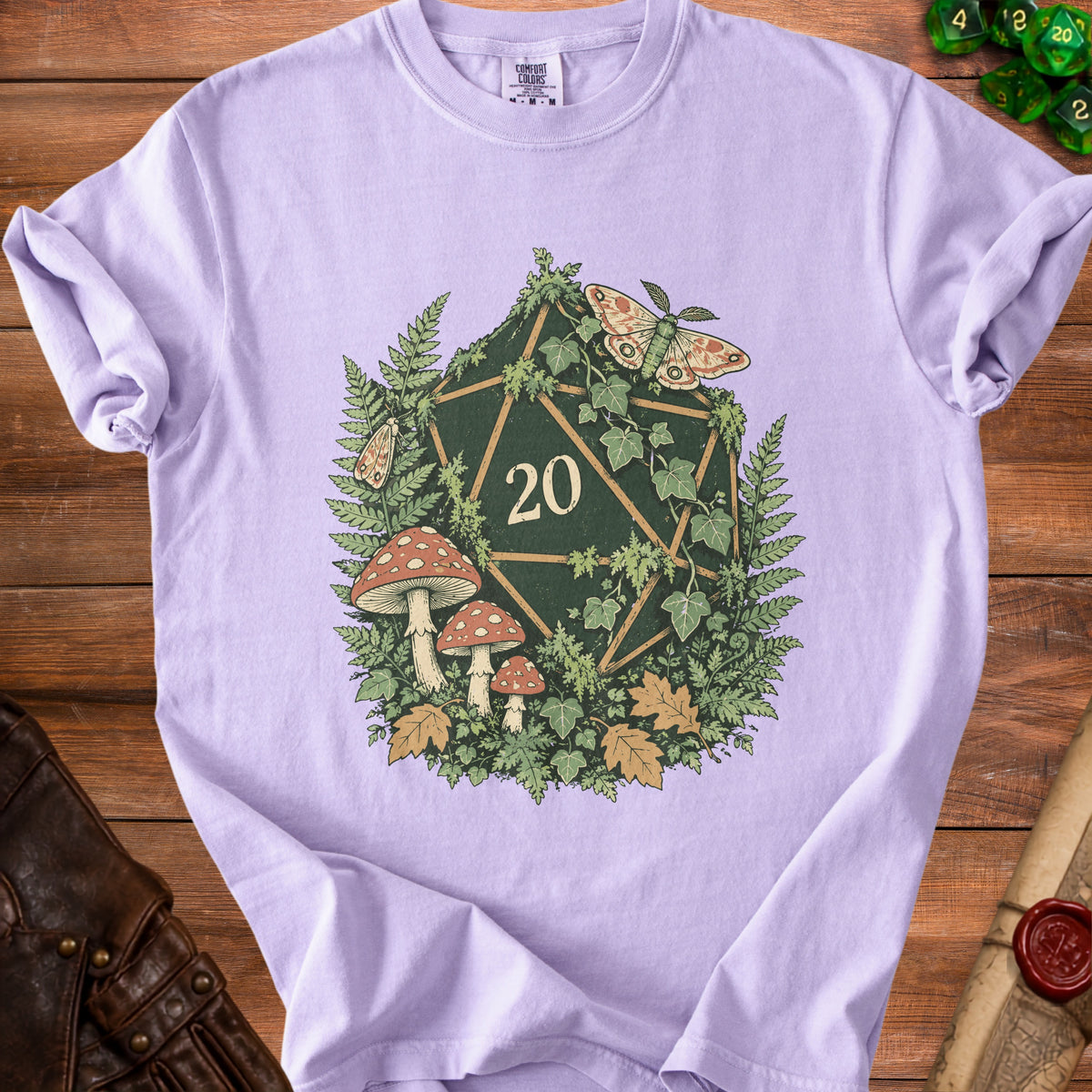 Purple t-shirt with a d20 dice design featuring mushrooms, ferns, and moths.