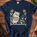 Navy t-shirt with graphic of owl and mouse near a witch hat and flowers.