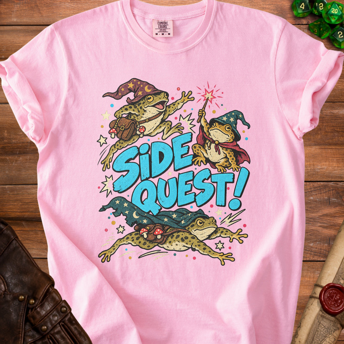 Pink t-shirt with graphic of three wizard frogs and the text "Side Quest!".