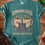 T-shirt with "Summoning Focus, The Ritual Takes Two Cups" and wizard graphic.
