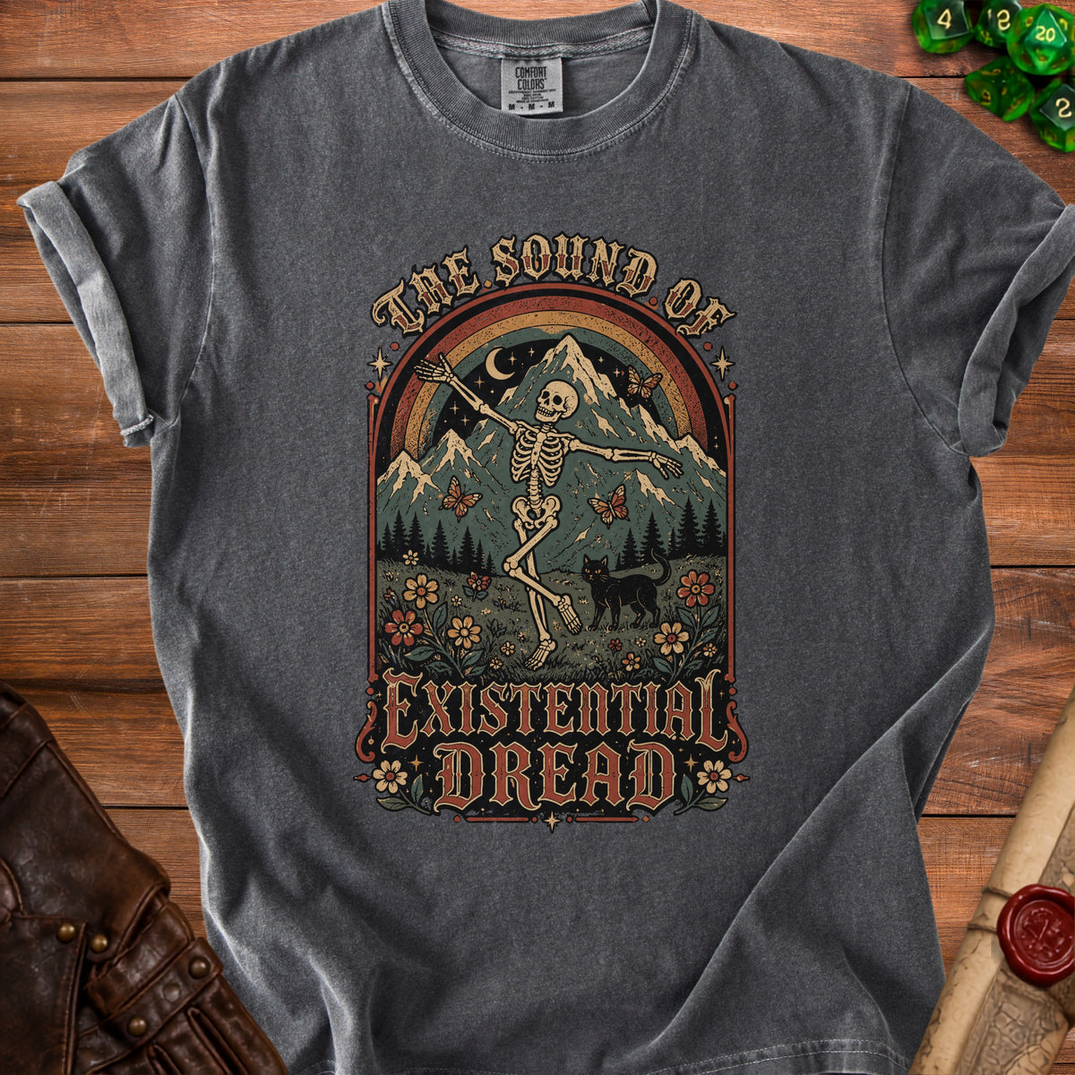 T-shirt with skeleton dancing, mountains, and text "The Sound of Existential Dread".