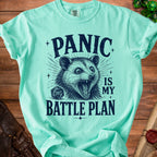 Teal t-shirt with opossum graphic and text "PANIC IS MY BATTLE PLAN".