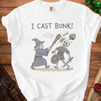 White t-shirt with "I CAST BONK!" text and wizard attacking skeleton.