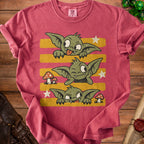 Red t-shirt with three green goblins with stripes, mushrooms, and stars.