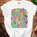 White t-shirt with "CURRENT STATUS FERAL & MAGICAL" text and cute graphics.