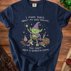 Navy t-shirt with goblin wizard graphic and text "I MAKE JOKES ABOUT MY OWN TRAUMA, YOU CAN'T KEEP A GANGSTA DOWN."