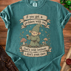 Teal t-shirt with gnome graphic and text "if you got a problem with me, that's wild because i don't even care".