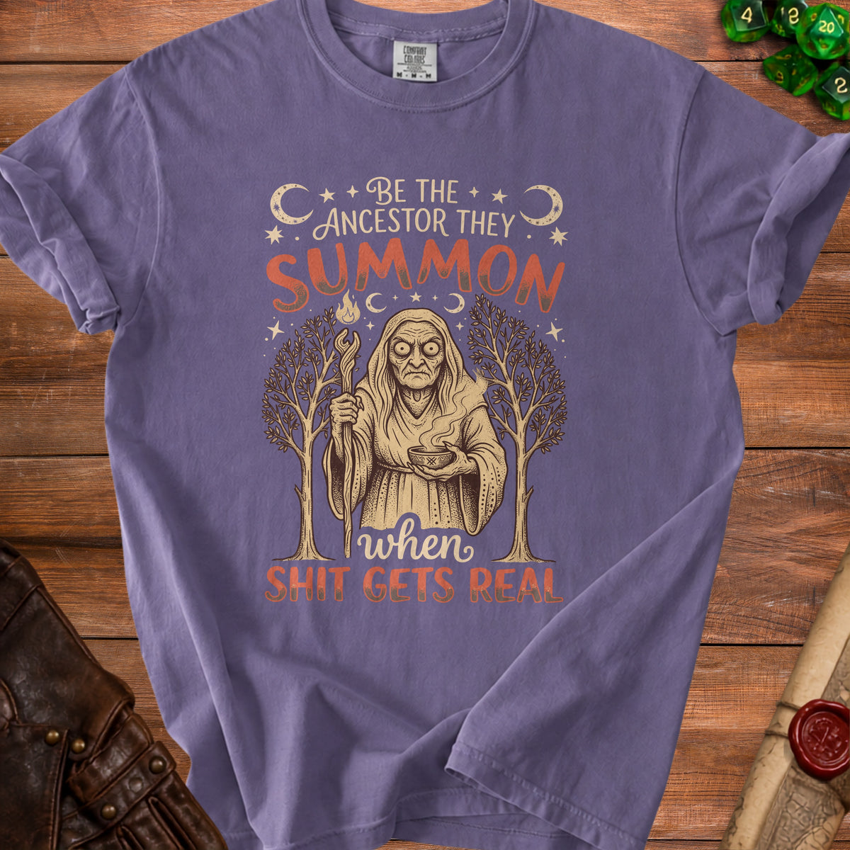 Purple t-shirt with "Be the ancestor they summon" and witch graphic.