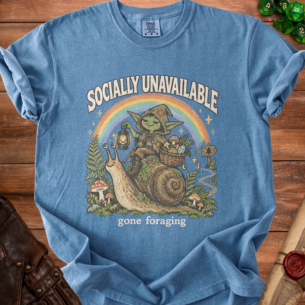 Blue t-shirt with illustration of a goblin on a snail, "Socially Unavailable gone foraging".