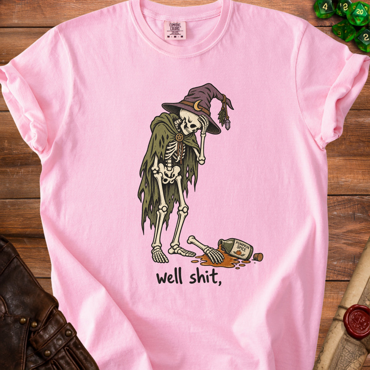 Pink t-shirt with skeleton wearing witch hat and spilling pumpkin spice.