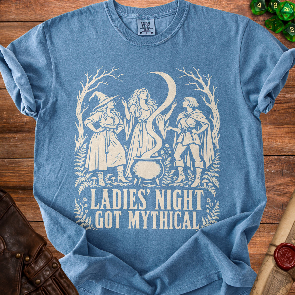 Blue t-shirt with three mythical women around a cauldron, text "Ladies' Night Got Mythical".